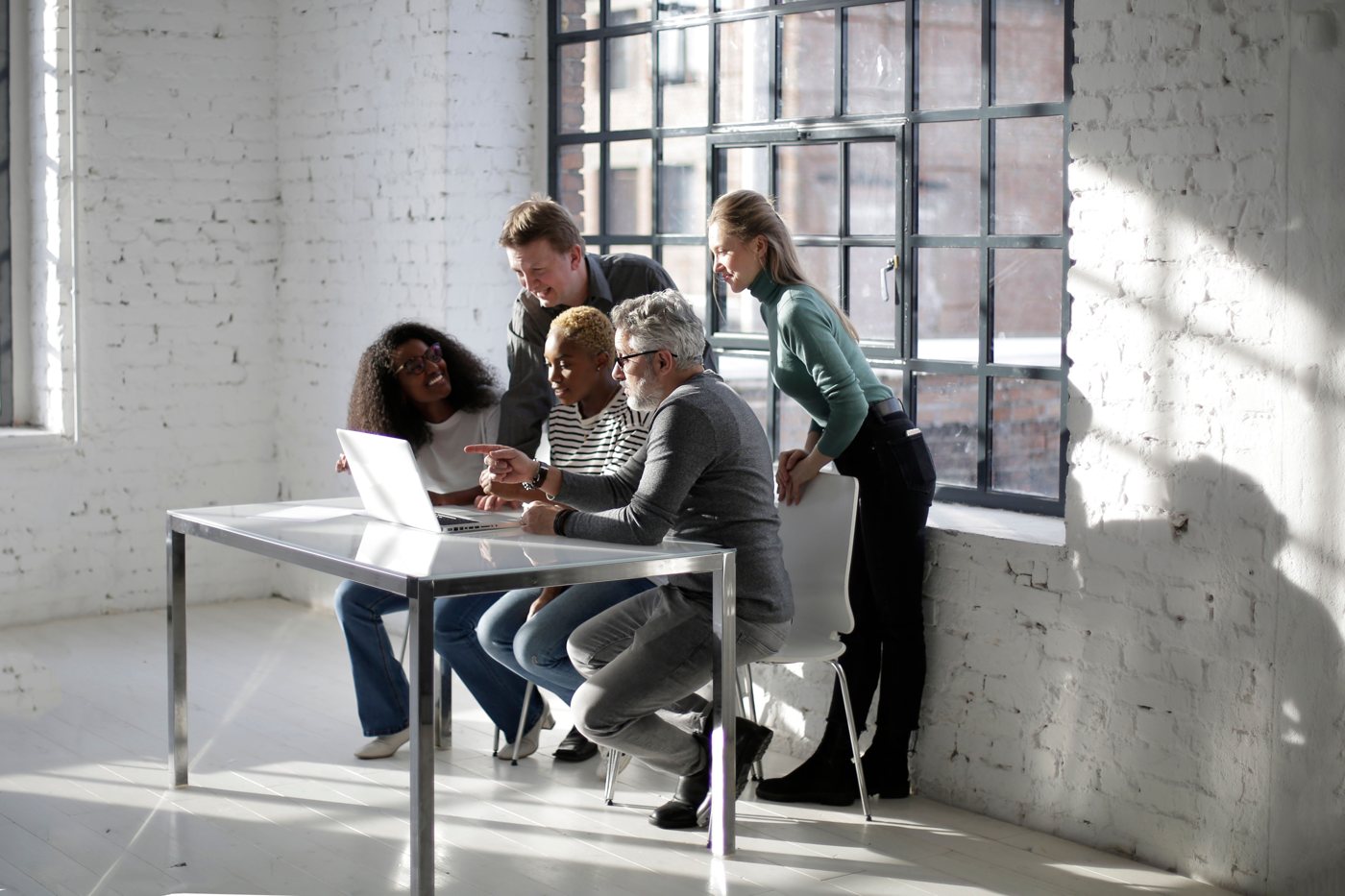 An office team discussing work at a computer